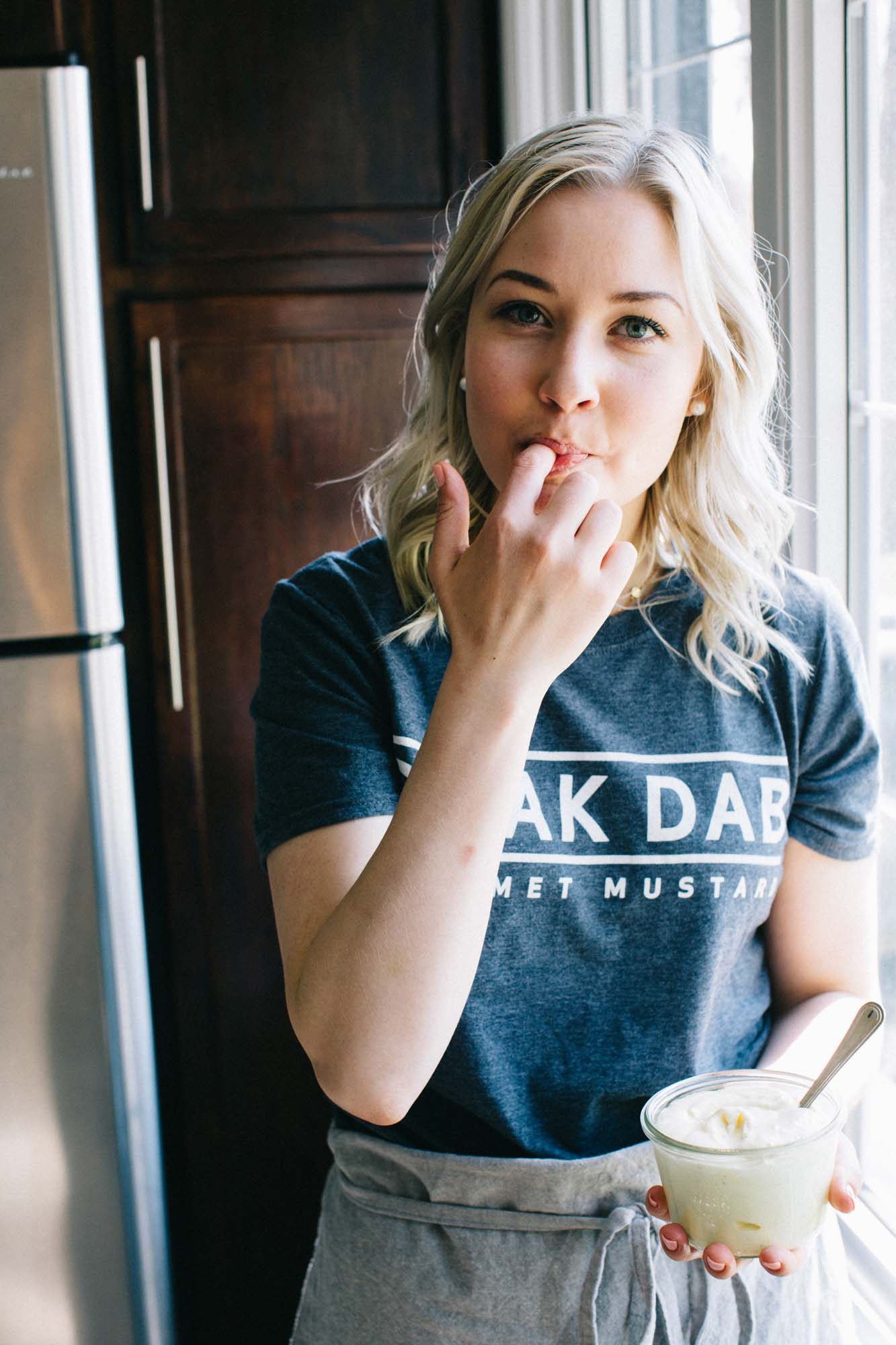 Smak Dab founder Carly tasting homemade mayonnaise on her finger
