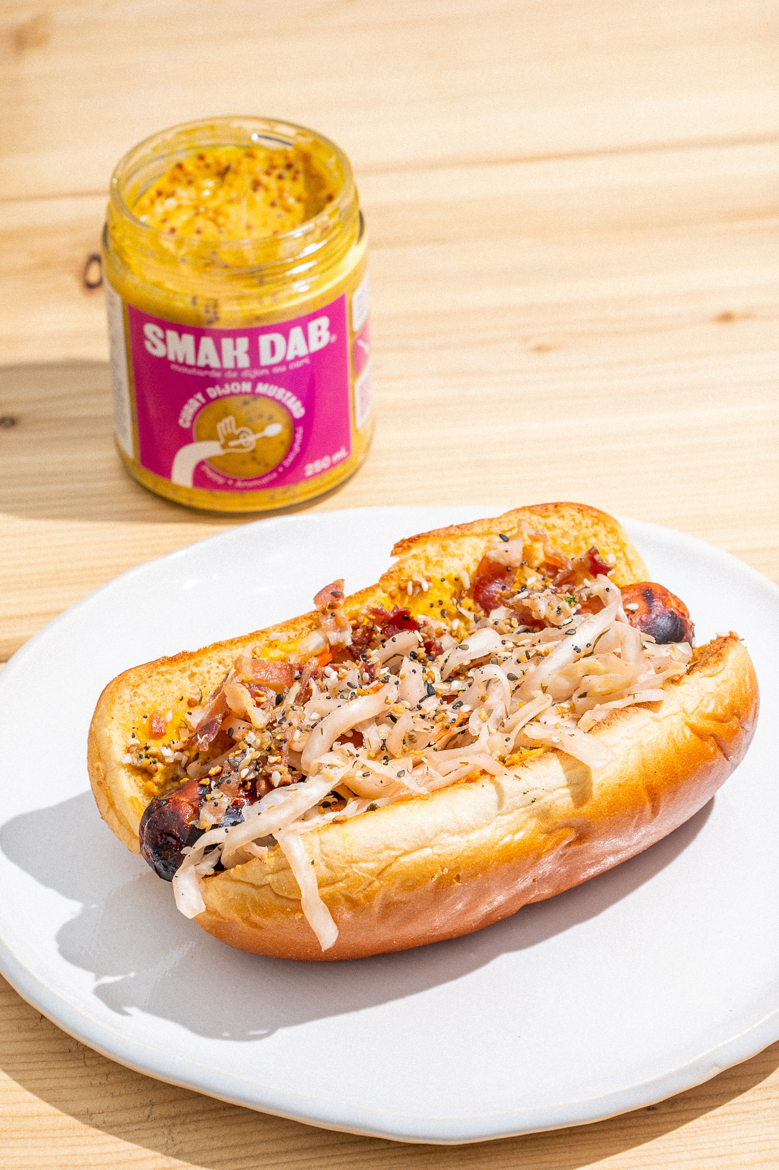 The Smak Dab Curry Dijon Everything Hot Dog on a White Plate