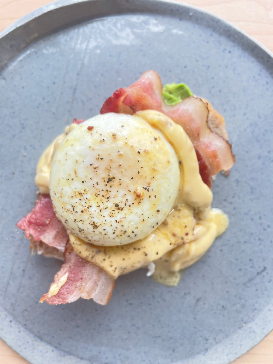 Smak Dab’s Egg Benedict with Savoury Maple Mustard Hollandaise on a grey ceramic plate