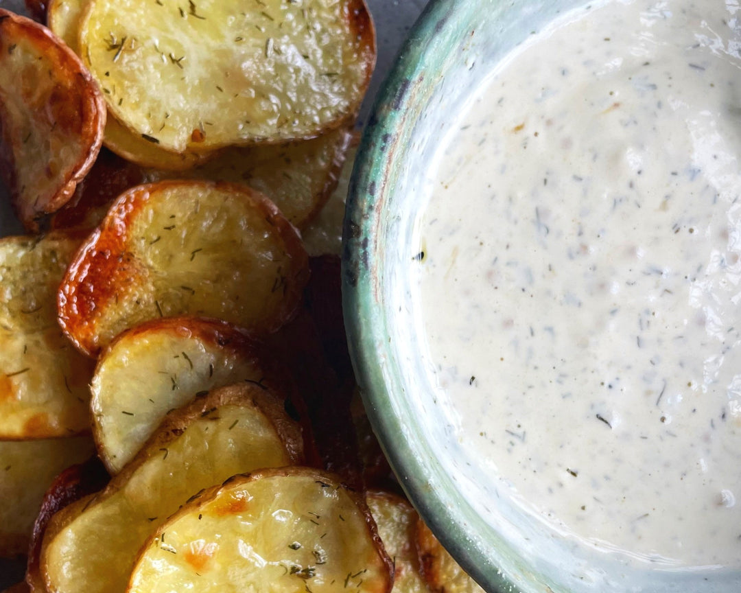 Crispy Oven Baked Potato Chips with Dill Pickle Ranch in a ceramic bowl