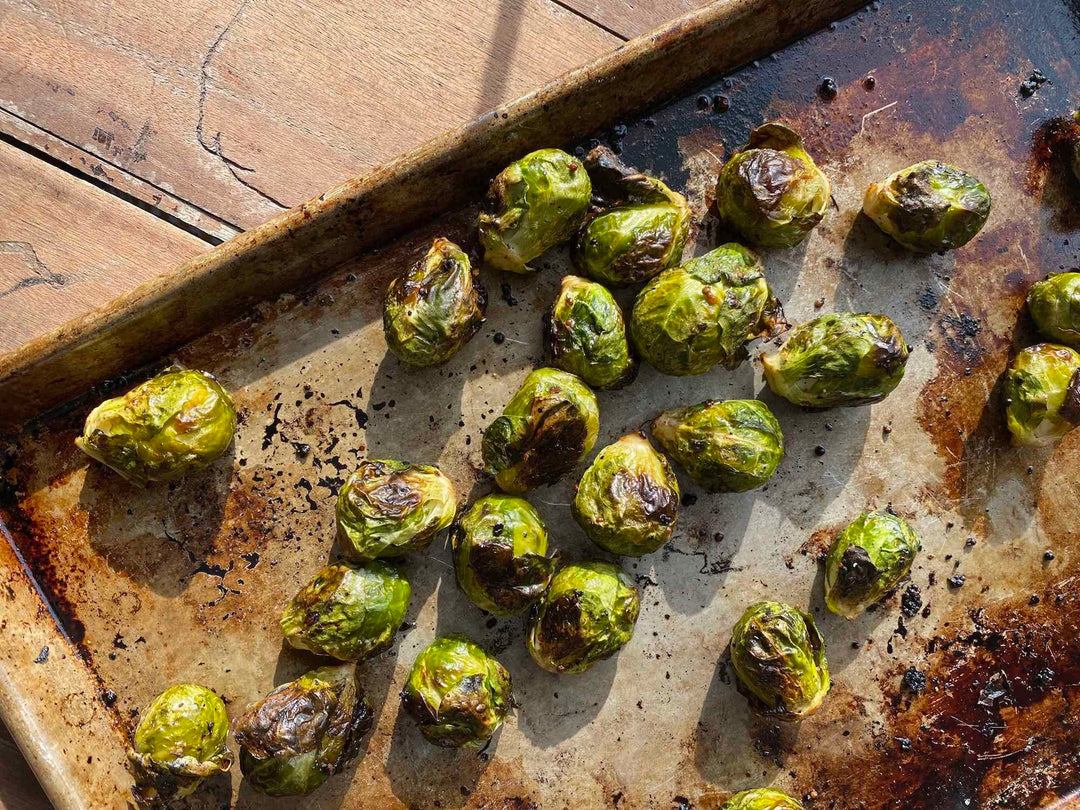 Whole Crispy Oven Roasted Brussels Sprouts on a baking tray